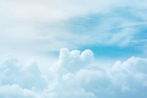 Soft cumulus fluffy clouds in bright azure sky as background photo