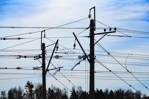 View of fragment a railway power line support a background of cloudy sky photo