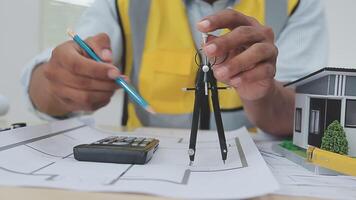 architect man working with laptop and blueprints,engineer inspection in workplace for architectural plan,sketching a construction project ,selective focus,Business concept vintage color video