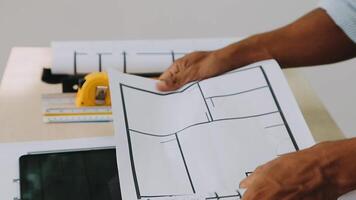 architect man working with laptop and blueprints,engineer inspection in workplace for architectural plan,sketching a construction project ,selective focus,Business concept vintage color video