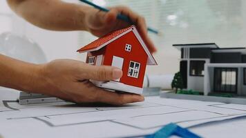 architect man working with laptop and blueprints,engineer inspection in workplace for architectural plan,sketching a construction project ,selective focus,Business concept vintage color video