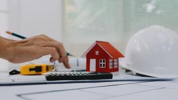 architect man working with laptop and blueprints,engineer inspection in workplace for architectural plan,sketching a construction project ,selective focus,Business concept vintage color video