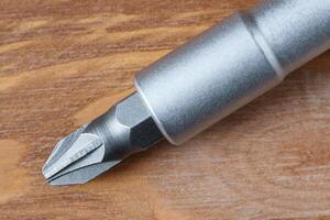Close up view of a screwdriver on a wooden table photo