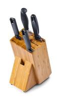 Natural bamboo stand with four stab knives isolated on white background with shadow photo