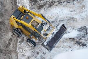 Top view on a snow-removing machine on a dirty street photo