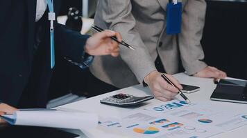 Young Asian businesswoman and businessman discuss investment project working and planning strategy on digital tablet. Business people talking together with tablet at office. video