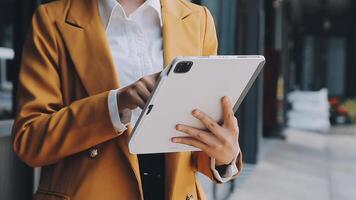 Young Asian businesswoman and businessman discuss investment project working and planning strategy on digital tablet. Business people talking together with tablet at office. video