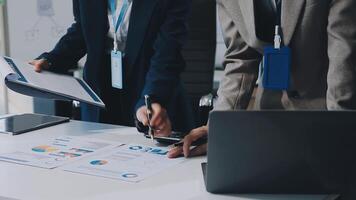 Young Asian businesswoman and businessman discuss investment project working and planning strategy on digital tablet. Business people talking together with tablet at office. video