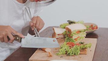 Closeup image of a chef cooking whole wheat sandwich and vegetables salad in kitchen video