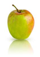 Light green apple with red spots isolated on a white background with mirror reflection photo