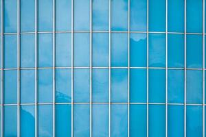 Abstract view of a fragment of facade of a modern glass building as texture, background photo