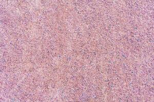 Texture of a gravel path of pink color as background photo