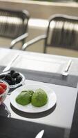 Fresh Avocado and Black Olives beautifully arranged on a table in an outdoor setting video
