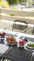 Enjoy a delightful outdoor breakfast on a sunny patio with a table set up, croissants, and fruits video