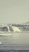 gigantic Ice block structures on the black sand by the sea shore video