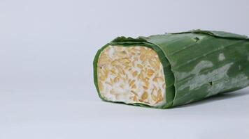 Raw tempe wrapped in banana leaves, Indonesian traditional food, create from soybean photo