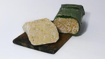 Raw tempe wrapped in banana leaves, Indonesian traditional food, create from soybean photo