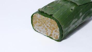Raw tempe wrapped in banana leaves, Indonesian traditional food, create from soybean photo
