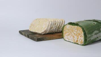 Raw tempe wrapped in banana leaves, Indonesian traditional food, create from soybean photo