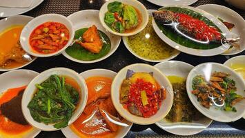 a table with many dishes of food on it photo