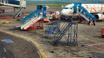 a large airplane on the tarmac with a ramp and a ramp photo