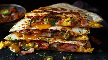 Breakfast quesadilla filled with scrambled eggs, bacon, cheese, and diced jalapenos, served with salsa. photo