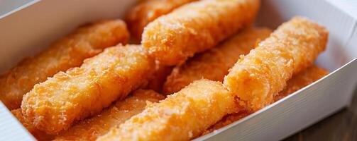 Box of frozen fish sticks made with flaky white fish and a crunchy coating. photo