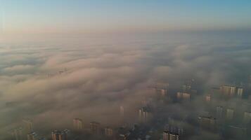 Aerial view of a megacity engulfed in a thick layer of smog, emphasizing the scale and severity of air pollution in densely populated urban areas. Air pollution bad ecology photo