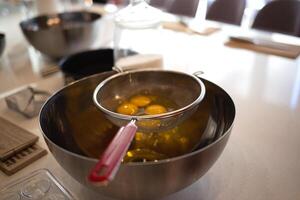 eggs in a bowl on the kitchen table for making a pie at a culinary master class photo