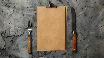 Clipboard with blank menu and cutlery on textured surface mockup photo