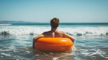 Interesting summer photo of a man with an inflatable ring