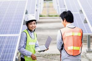 Female electrical engineering team and worker seller install solar photovoltaic panels Clean and environmentally friendly alternative energy Unity and teamwork. photo