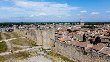 Fortified city of Aigues-Mortes, in Provence in France. Entirely surrounded by an imposing city wall and purple salt pans of incredible beauty, Aigues-Mortes is a jewel, an enchanting medieval village photo