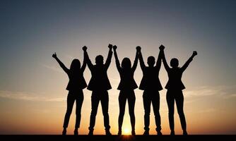 Silhouette of business team stand and feel happy on the most high at stand on sunset photo