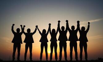 Silhouette of business team stand and feel happy on the most high at stand on sunset photo