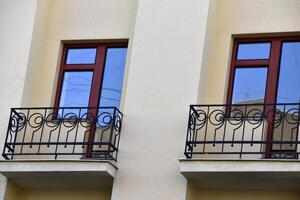 A red window on a yellow wall. A beautiful window in a classic building. photo