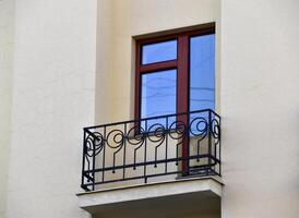 A red window on a yellow wall. A beautiful window in a classic building. photo