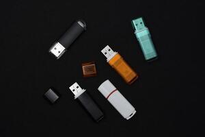 USB flash drives on a black background. The information carrier. Several flash drives. photo