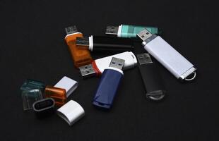 USB flash drives on a black background. The information carrier. Several flash drives. photo