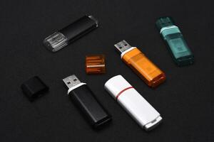 USB flash drives on a black background. The information carrier. Several flash drives. photo