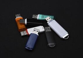 USB flash drives on a black background. The information carrier. Several flash drives. photo