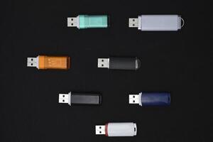 USB flash drives on a black background. The information carrier. Several flash drives. photo