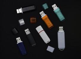 USB flash drives on a black background. The information carrier. Several flash drives. photo