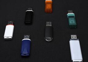 USB flash drives on a black background. The information carrier. Several flash drives. photo