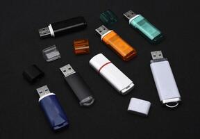 USB flash drives on a black background. The information carrier. Several flash drives. photo
