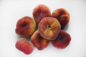Flat peaches on a white background. Peaches in a package. photo