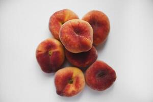 Flat peaches on a white background. Peaches in a package. photo