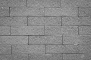 Brown brick wall with a uniform pattern and rough texture. photo