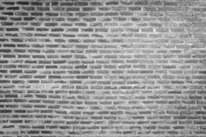 Red brick wall background with uneven texture and varying brick sizes. photo