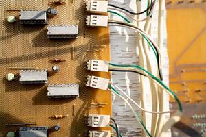 A tangled mess of wires and cords. The wires are all different colors and lengths. Concept of chaos and disorganization photo
